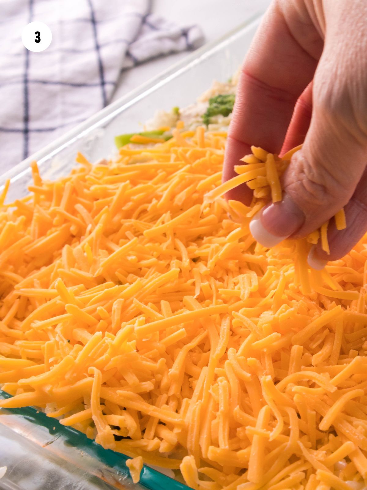 Shredded cheese added to top of casserole.