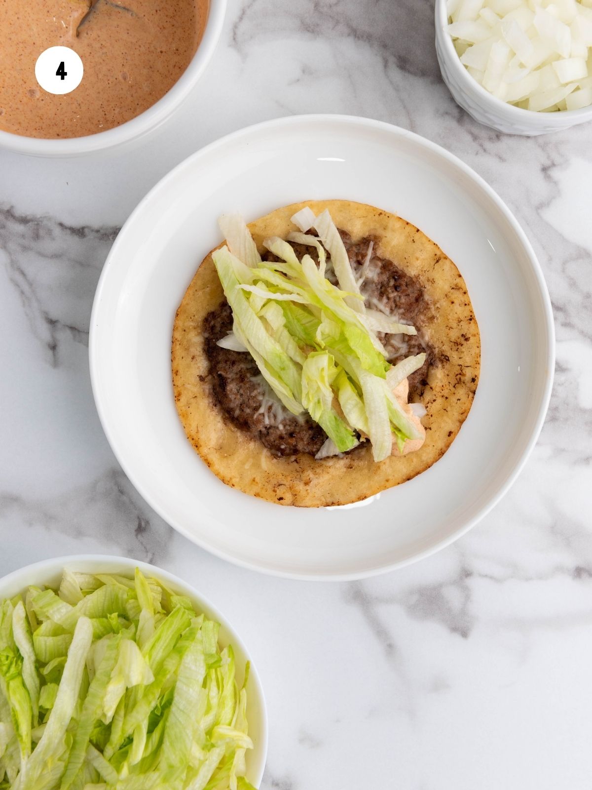 Shredded lettuce added on the taco.
