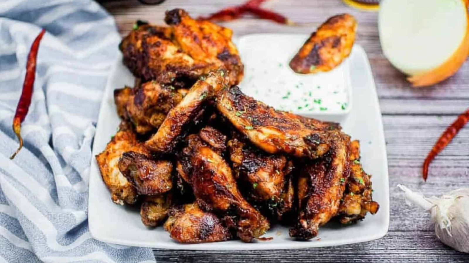 A pile of air fryer BBQ wings on a white platter.