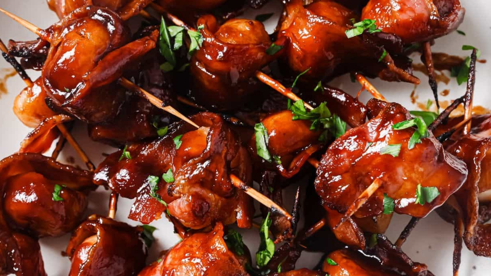 Bacon-wrapped water chestnuts on a plate.