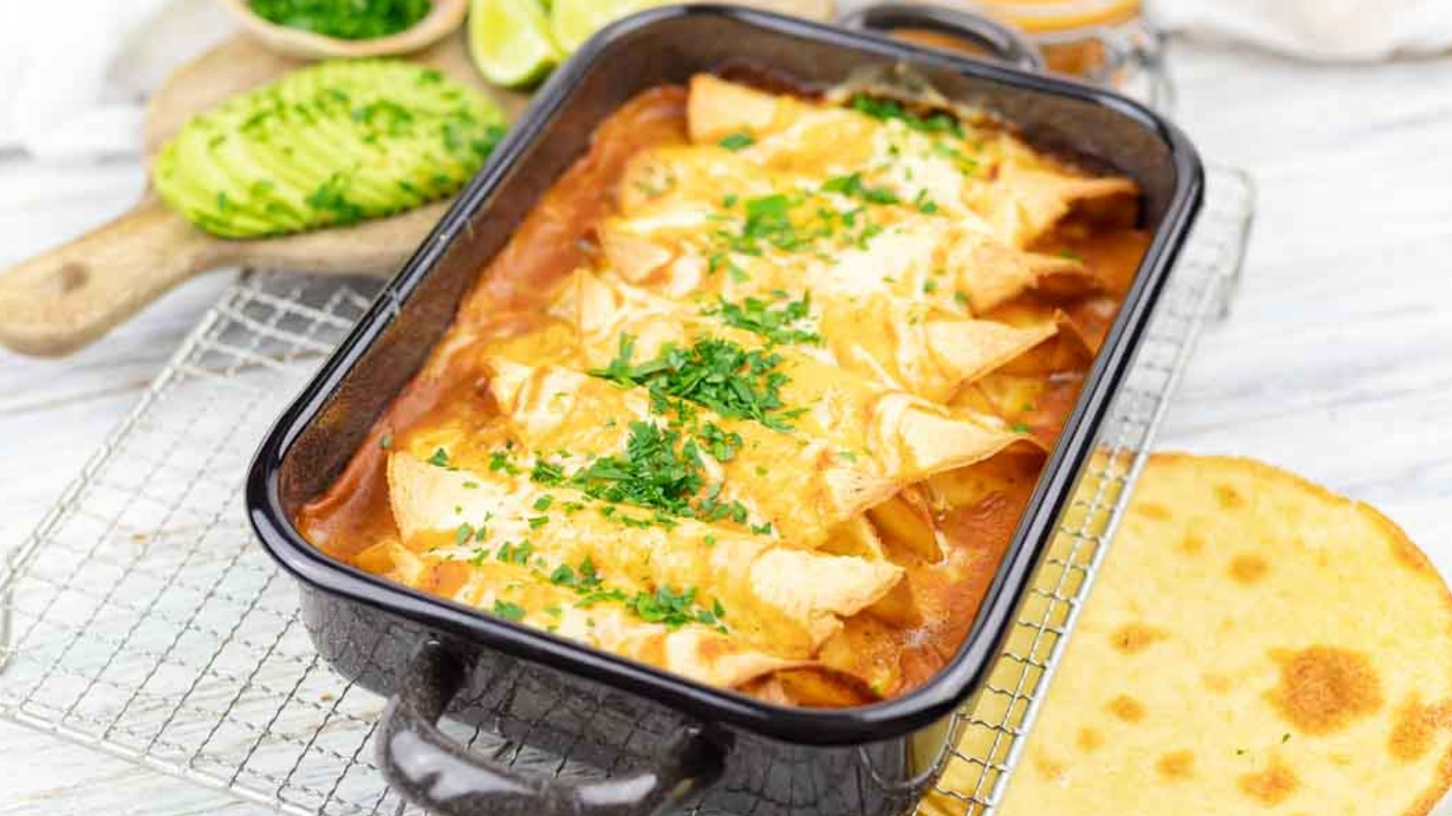 A pan of baked chicken enchiladas casserole.