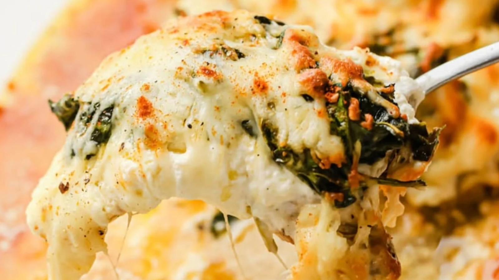 Chicken pot pie soup in a white bowl with a spoon.