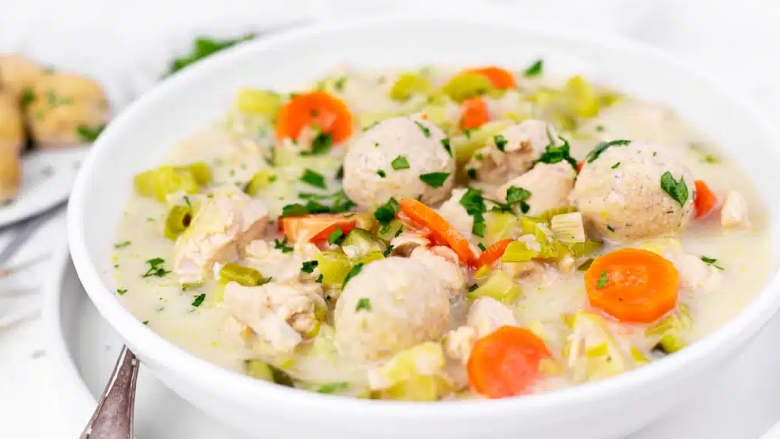 A bowl of homemade chicken soup with dumplings.