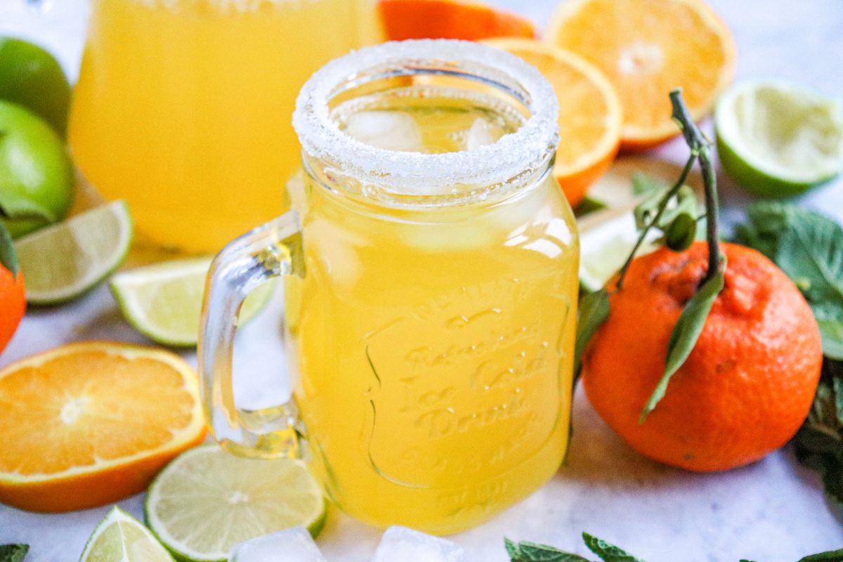 Orange juice mocktail served with a salted rim and lime garnish.