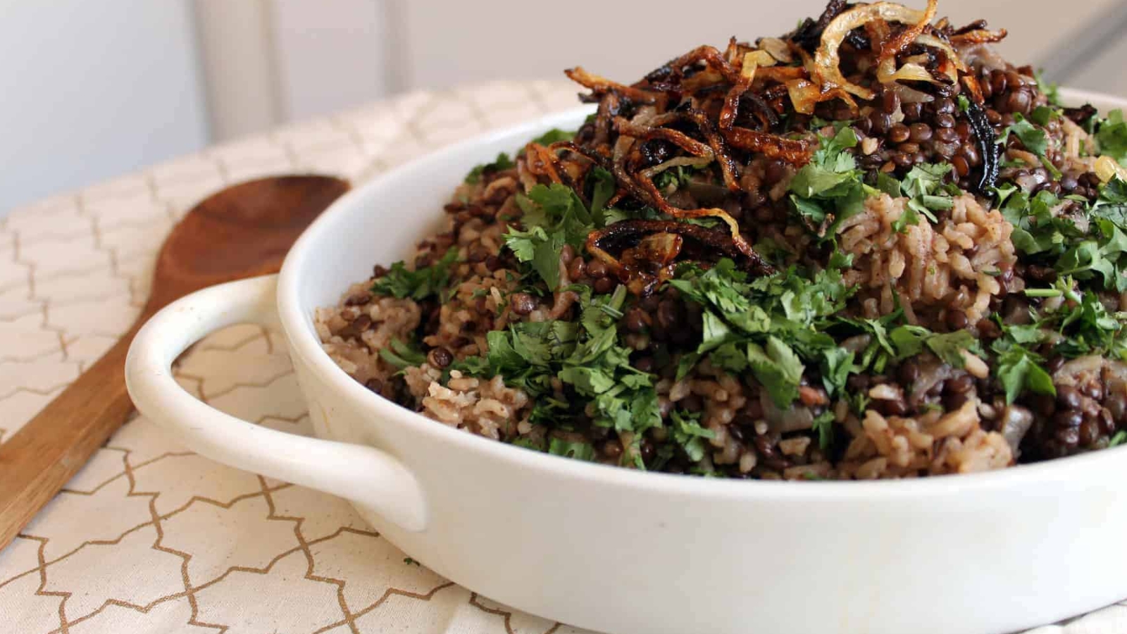 White casserole dish with middle eastern mujadara.