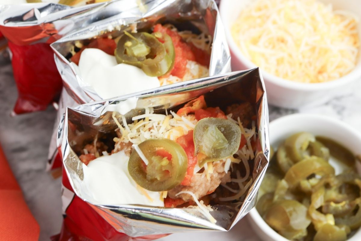 Little bags of Doritos and Fritos filled with taco toppings.