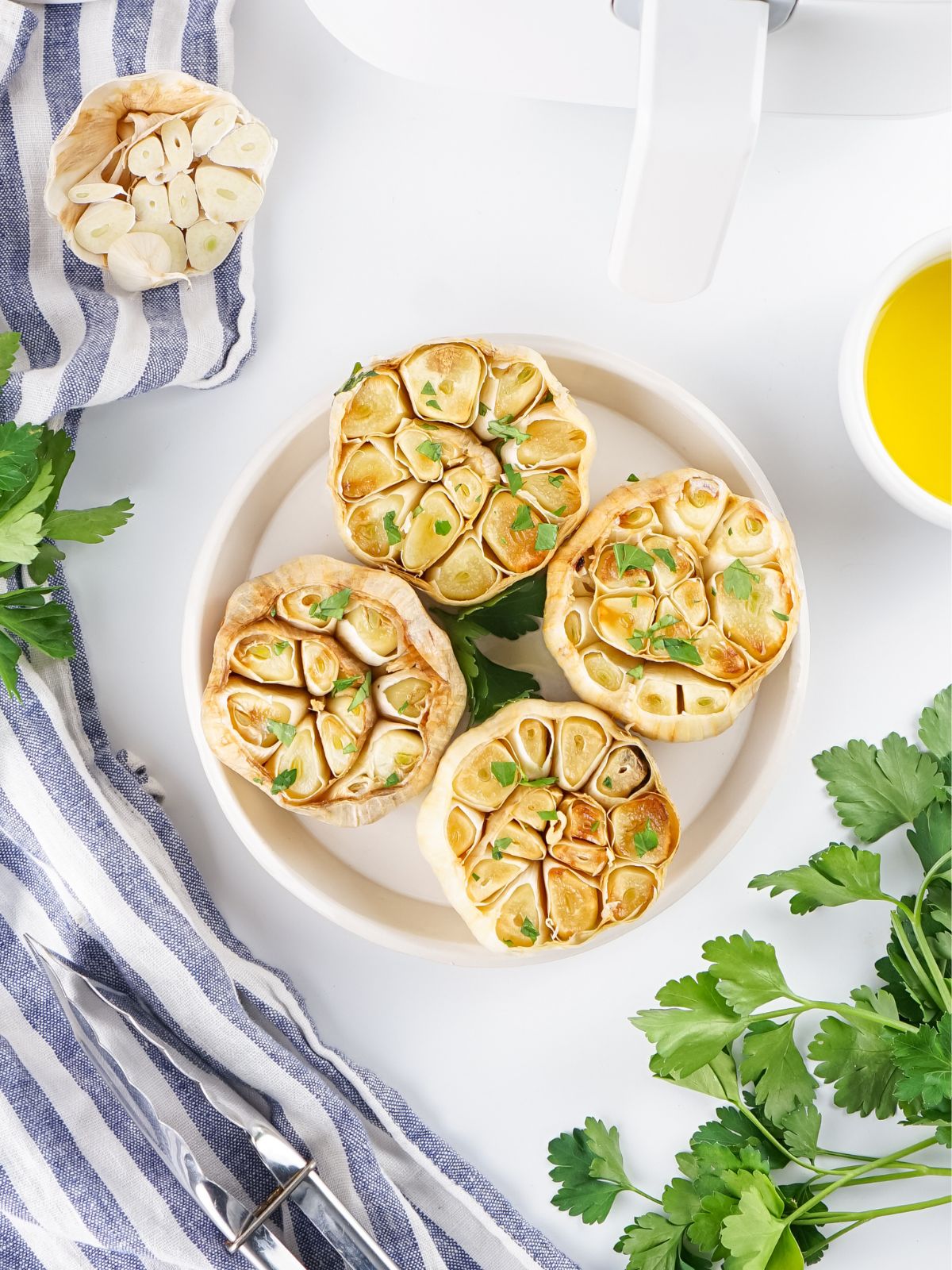 Overhead view of garlic bulbs roasted in the air fryer.