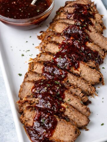 slow cooker brisket on white platter.