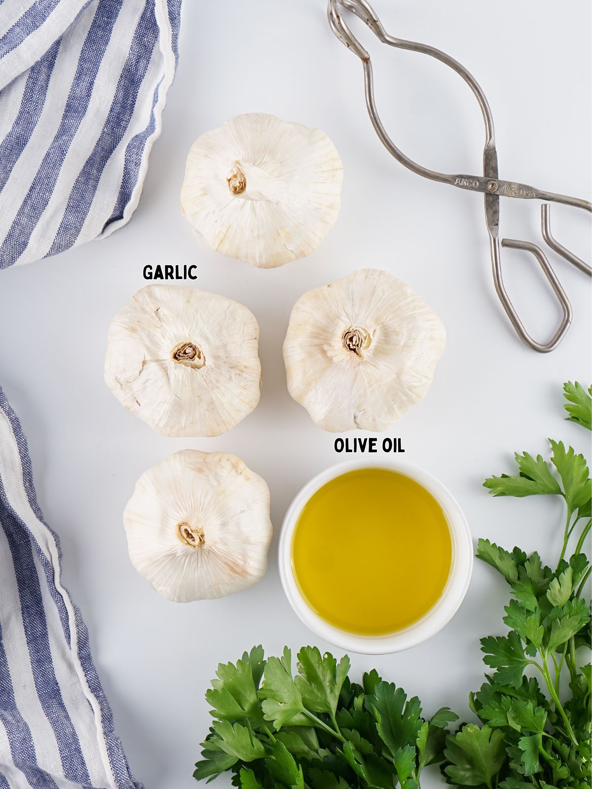 Four heads of garlic and a small ramekin of olive oil.