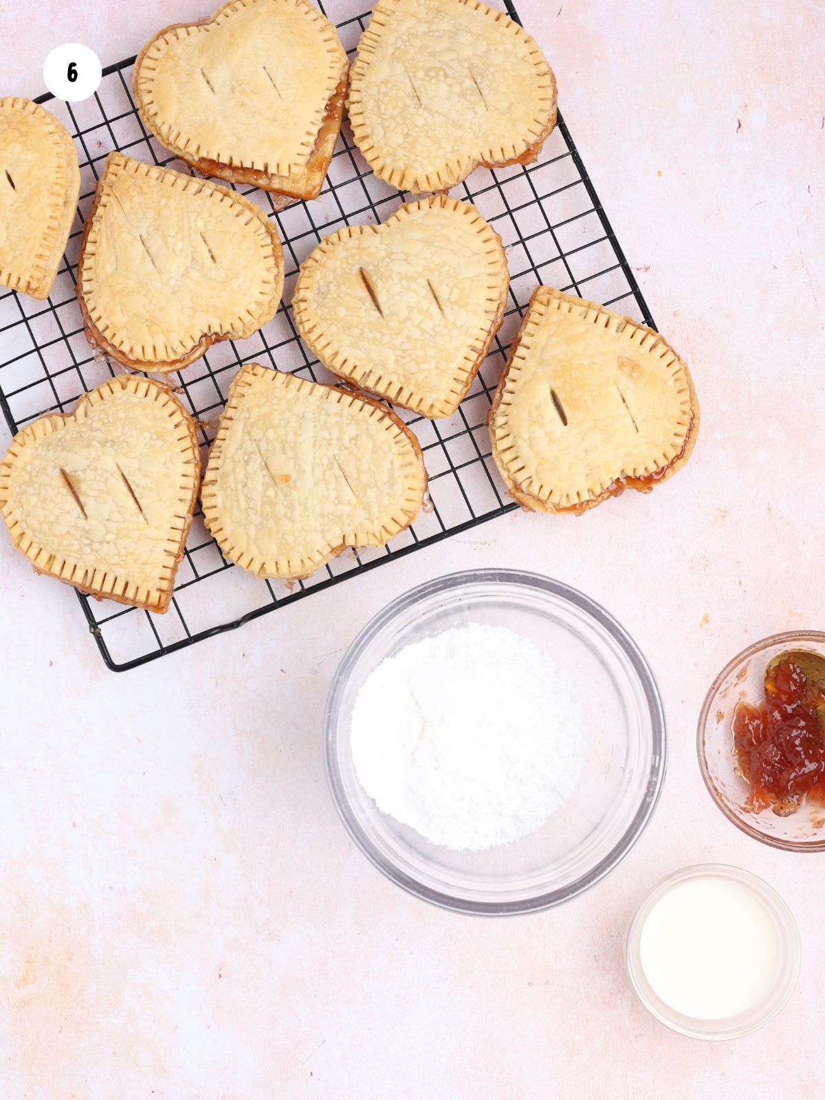 Powdered sugar glaze prepared for drizzling over strawberry hand pies.