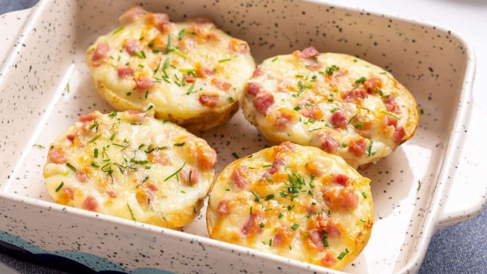 Four twice baked potatoes in a small baking dish.