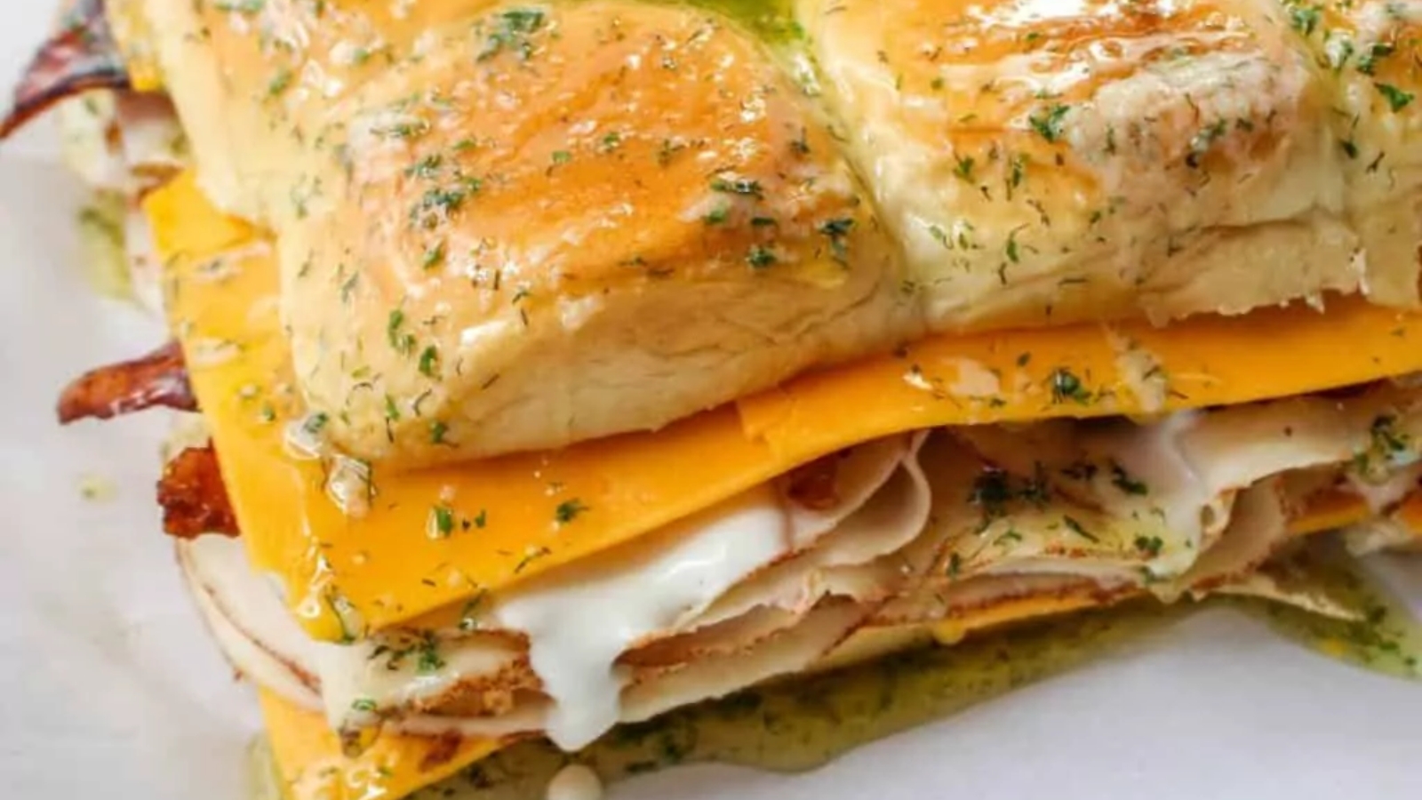 A tray of ham and cheese sliders.