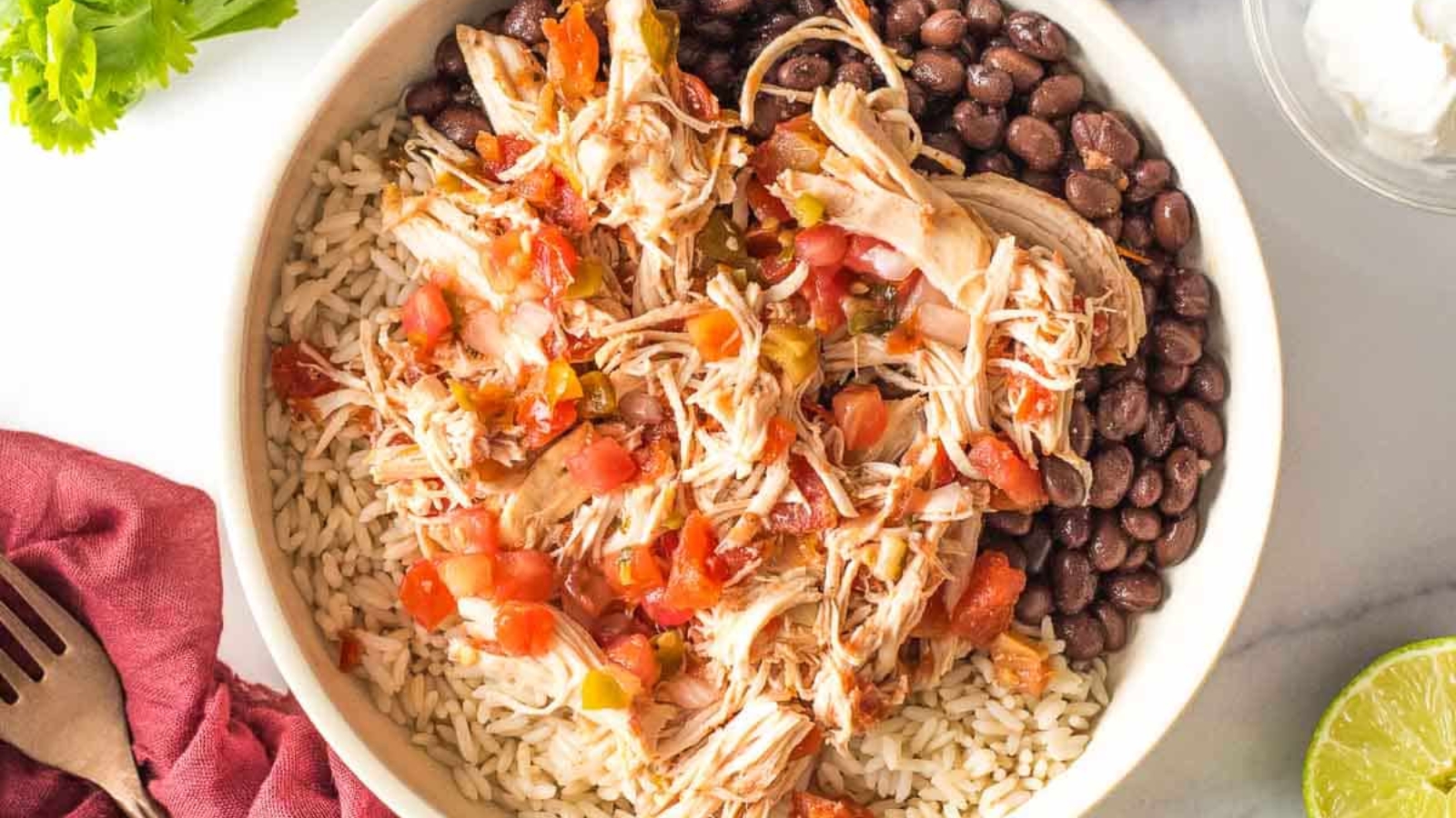 Slow cooker salsa chicken with rice and beans on a plate.