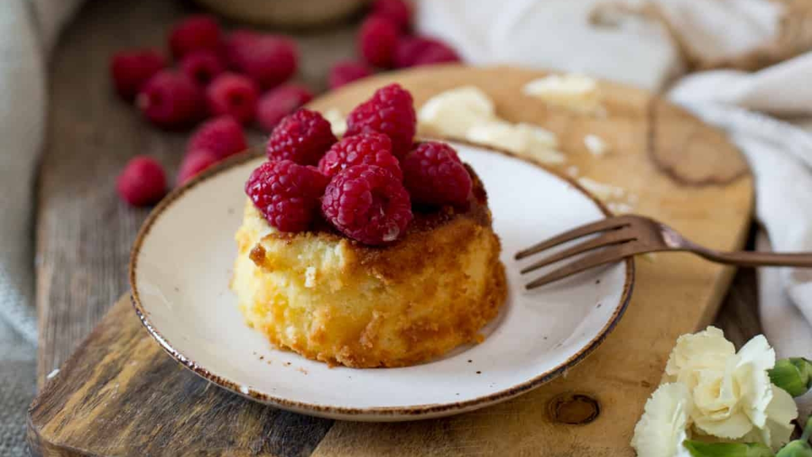 A spoonful of raspberry bread pudding on a plate.