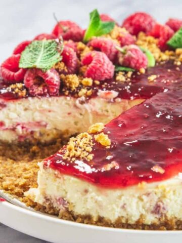 Raspberry ricotta cheesecake with a raspberry swirl on top.