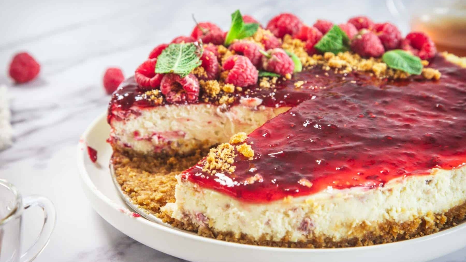 Raspberry ricotta cheesecake with a raspberry swirl on top.