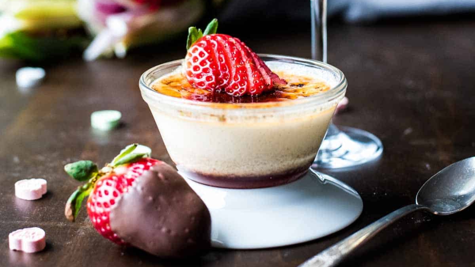 Strawberry crème brûlée with caramelized sugar crust and fresh berries.