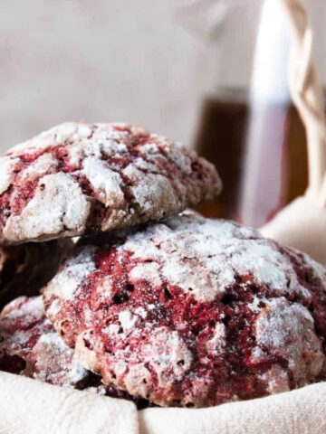 A stack of Valentine red velvet cookies with in a basket.