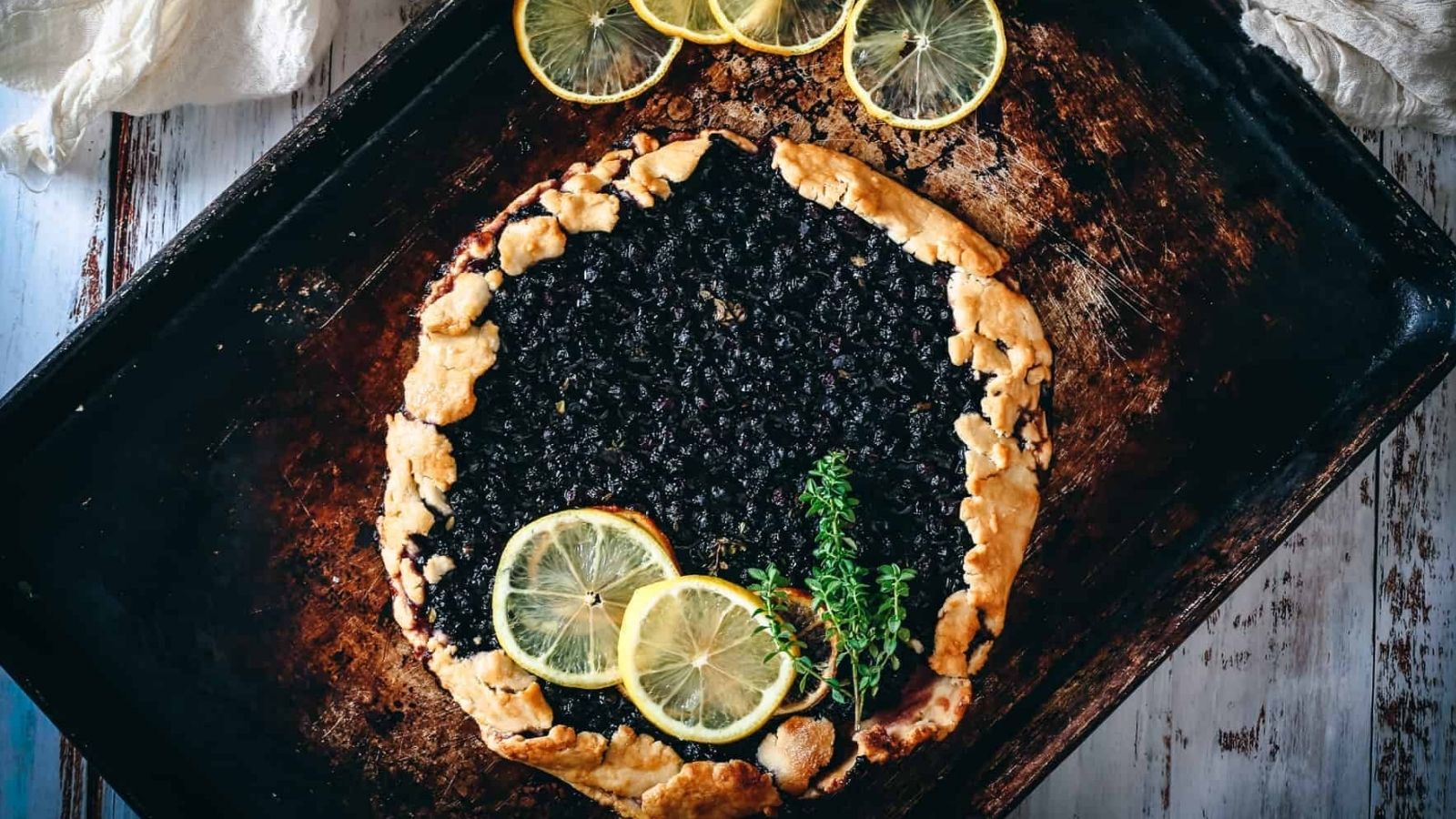Blueberry galette with lemon slices on top.