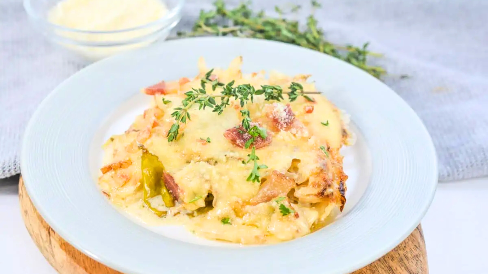 A casserole dish filled with cabbage, cheese and bacon.