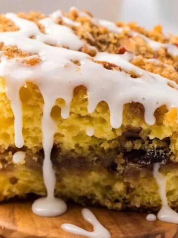 A square piece of crumb-topped cake arranged on a surface.