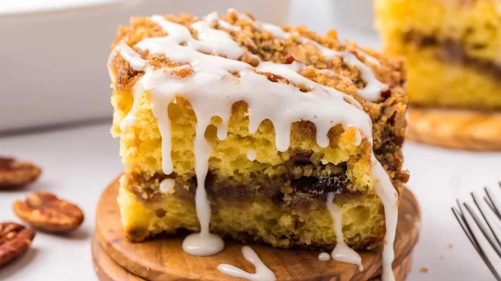 A square piece of crumb-topped cake arranged on a surface.