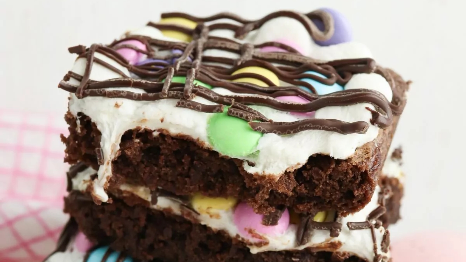 Easter brownies with colorful pastel decorations on a plate.