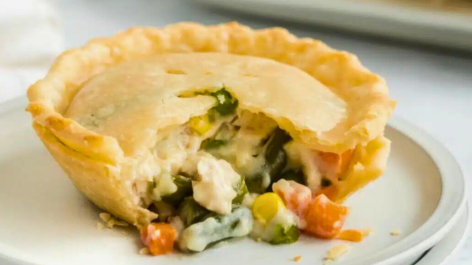 Homemade Chicken Pot Pie: Baked pie filled with creamy chicken and vegetables under a pastry crust.