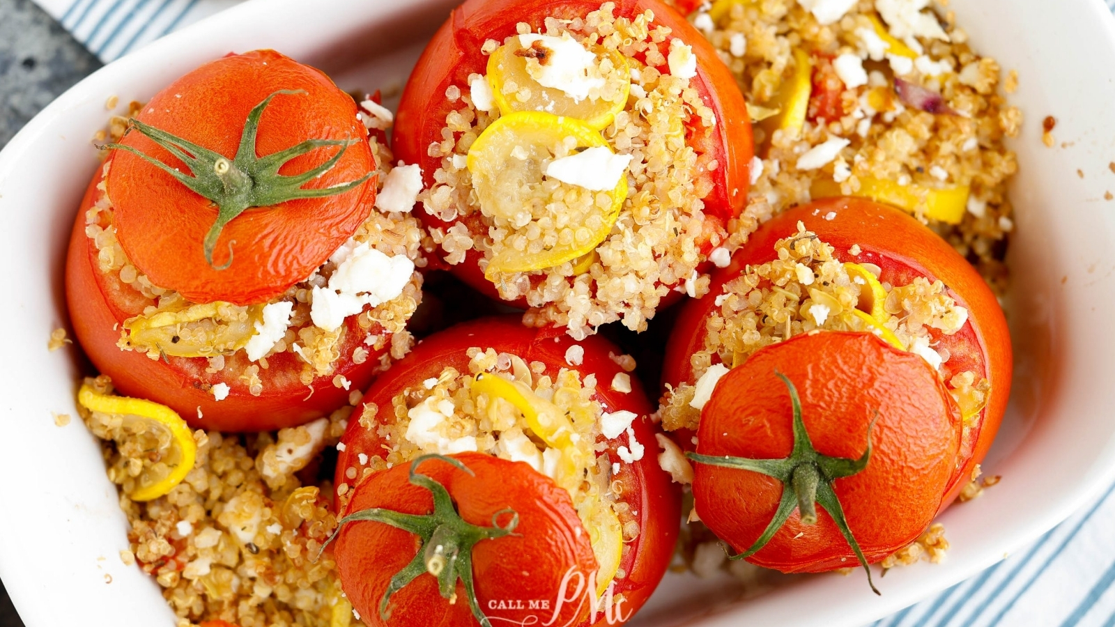 Flatlay of stuffed tomatoes with 'lids' on.