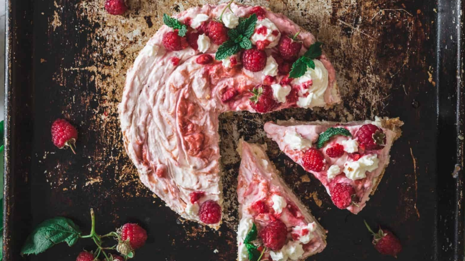 Overhead of sliced raspberry cheesecake.