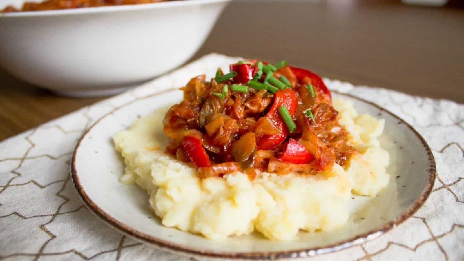 A plate with mashed potatoes and meat on it.