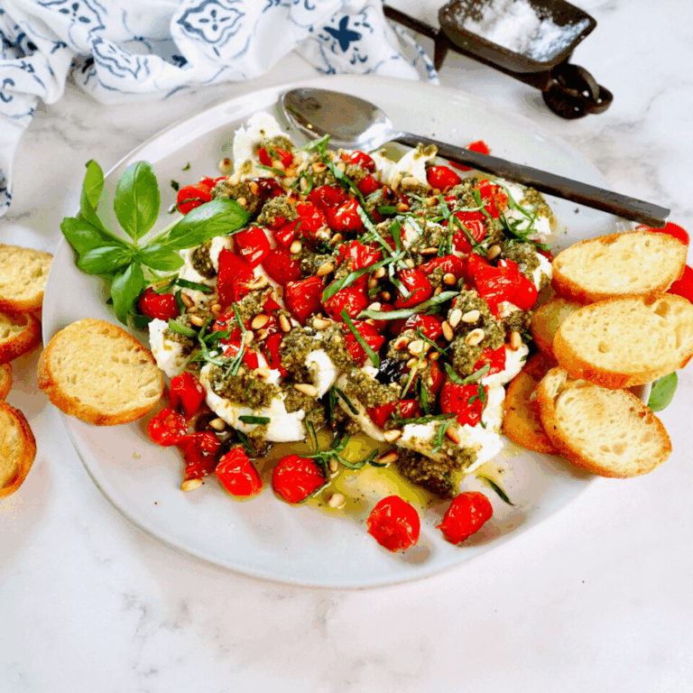 Pesto Appetizer Recipe with Burrata and Roasted Tomatoes in a plate
