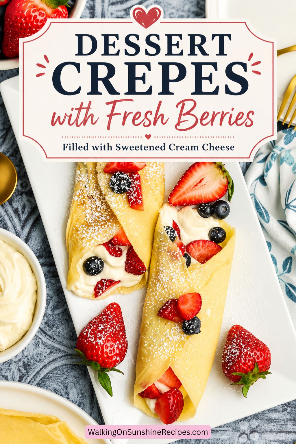Pinterest graphic for dessert crepes with fresh berries and sweetened cream cheese filling on a white serving platter topped with powdered sugar and strawberries.