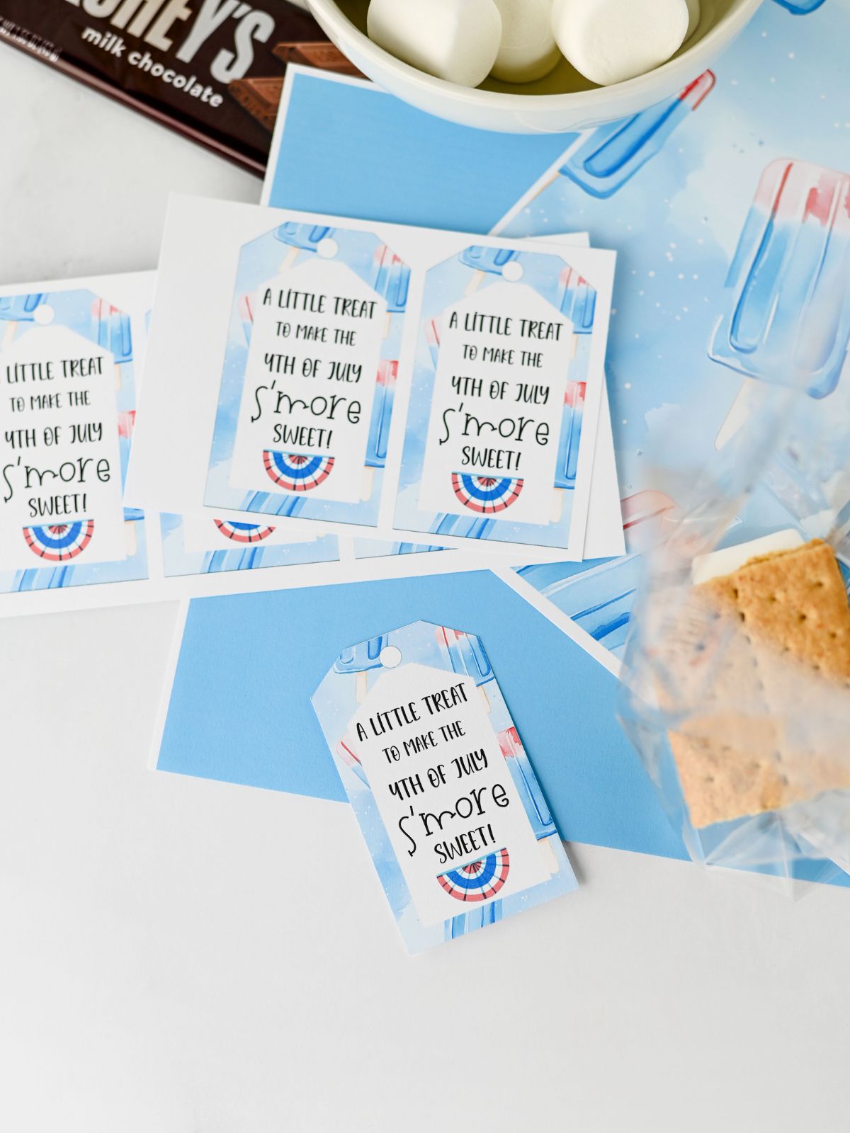 S’mores to go party favor with graham crackers, chocolate, marshmallows, and red white and blue tag.
