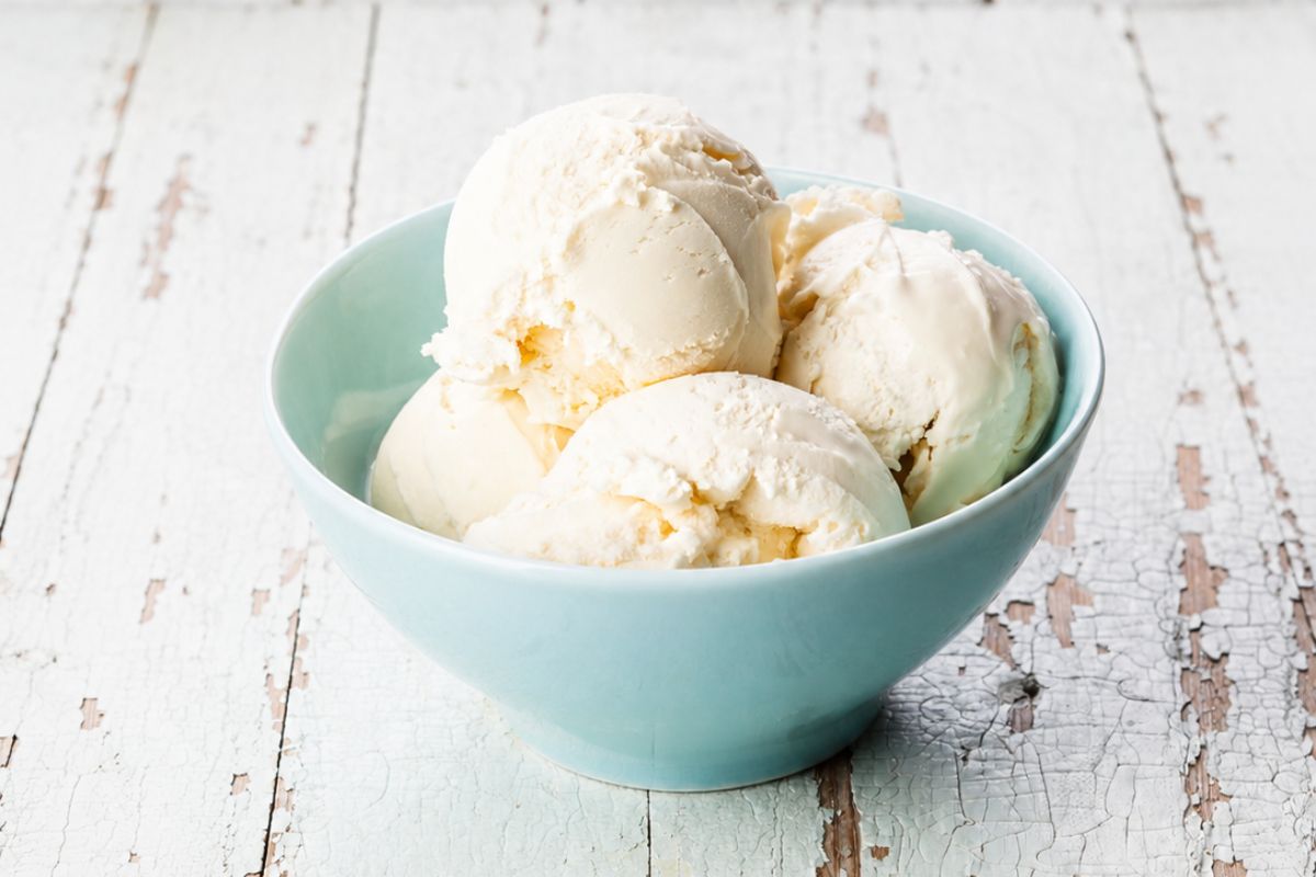 Homemade vanilla ice cream in a blue bowl made in a 4-quart ice cream maker.