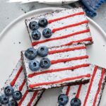 Pinterest graphic featuring American Flag Brownies decorated with powdered sugar, red icing, and fresh blueberries for an easy 4th of July dessert.