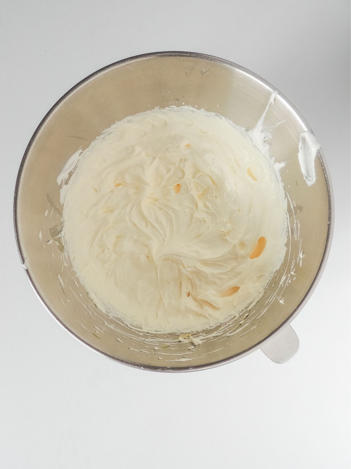 Mixing bowl with homemade frosting made with pudding and Cool Whip.